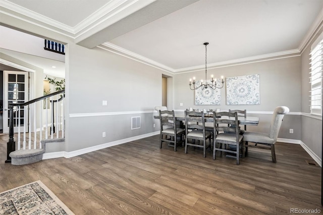 21854 Tyrolite Ave, Parker, CO 80138 - dining space featuring wood finished floors, a chandelier, stairs, baseboards, and crown molding