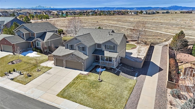 drone / aerial view featuring a residential view and a mountain view