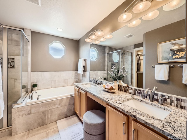 full bath with a bath, a shower stall, visible vents, and a sink