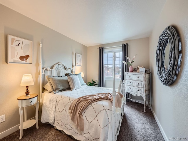 bedroom featuring dark carpet and baseboards