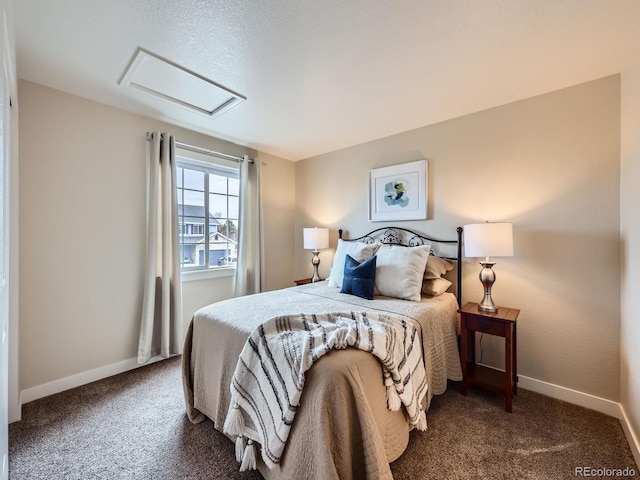 bedroom with attic access, baseboards, and carpet flooring