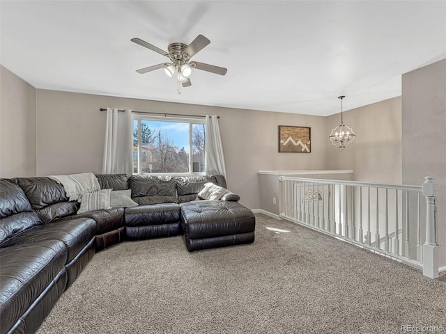 living area featuring baseboards, carpet flooring, and ceiling fan with notable chandelier