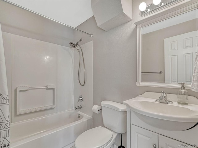 bathroom with toilet, vanity, and shower / bathtub combination