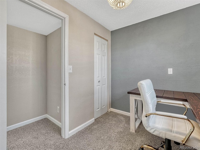 office space with carpet floors, baseboards, and a textured ceiling