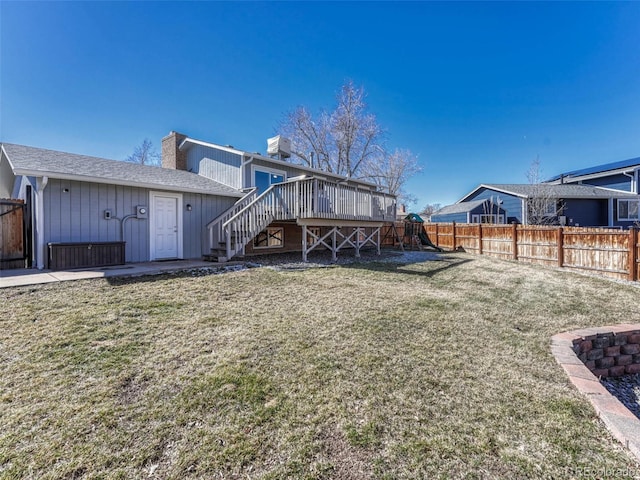 rear view of house featuring a fenced backyard, a yard, stairway, and central AC unit