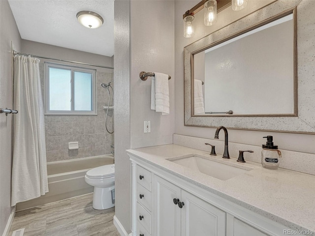 full bath featuring toilet, wood finished floors, shower / bath combo with shower curtain, and vanity