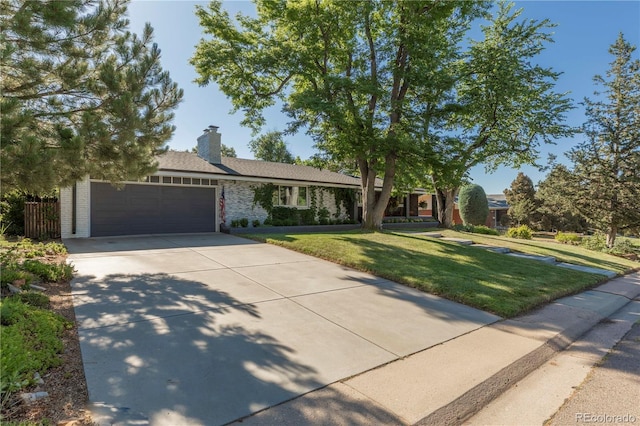 6760 S Depew St, Littleton, CO 80128 - ranch-style home featuring an attached garage, concrete driveway, a front yard, a chimney, and brick siding
