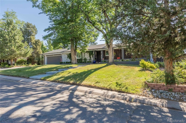 6760 S Depew St, Littleton, CO 80128 - view of front of property featuring a garage, a front yard, and concrete driveway