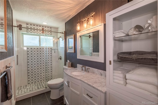 6760 S Depew St, Littleton, CO 80128 - full bath featuring a stall shower, vanity, a textured ceiling, and tile patterned floors