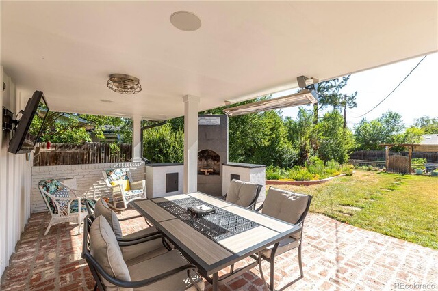 6760 S Depew St, Littleton, CO 80128 - view of patio / terrace with an outdoor fireplace and outdoor dining area