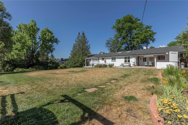 6760 S Depew St, Littleton, CO 80128 - view of green lawn featuring a patio
