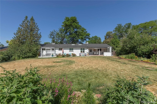 6760 S Depew St, Littleton, CO 80128 - rear view of house featuring a lawn