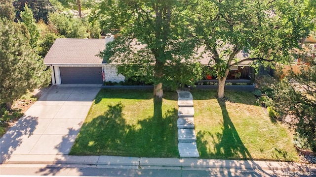 6760 S Depew St, Littleton, CO 80128 - view of front of house with a front lawn, concrete driveway, and a garage