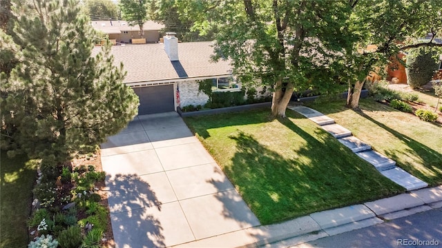 6760 S Depew St, Littleton, CO 80128 - view of front of house with a garage, a front yard, a chimney, and brick siding