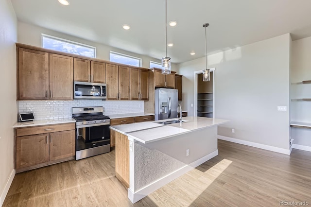 9436 E 57h Ave, Denver, CO 80238 - kitchen featuring appliances with stainless steel finishes, backsplash, light countertops, and recessed lighting