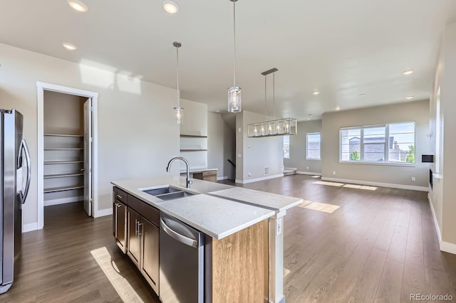 9436 E 57h Ave, Denver, CO 80238 - kitchen featuring appliances with stainless steel finishes, wood finished floors, light countertops, open floor plan, and recessed lighting