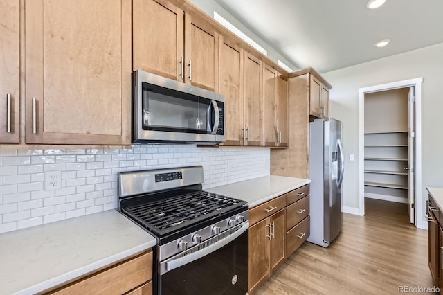9436 E 57h Ave, Denver, CO 80238 - kitchen with stainless steel appliances, light wood-style floors, tasteful backsplash, and recessed lighting