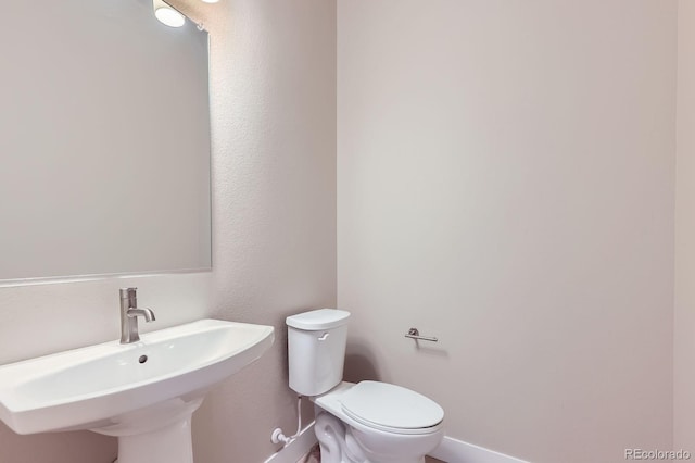 9436 E 57h Ave, Denver, CO 80238 - bathroom with toilet and baseboards