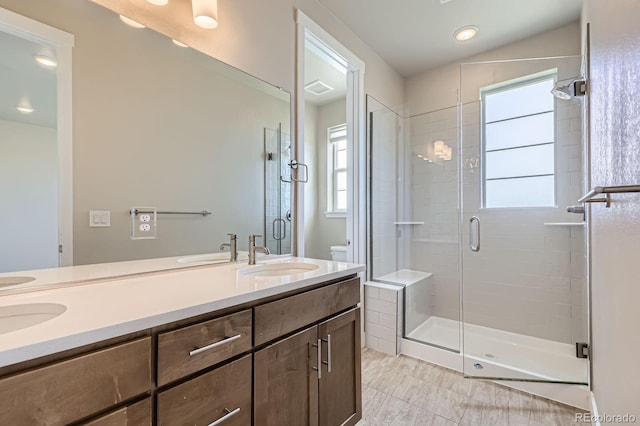 9436 E 57h Ave, Denver, CO 80238 - full bath featuring a shower stall, double vanity, and healthy amount of natural light
