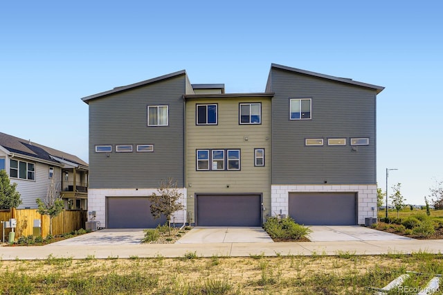 9436 E 57h Ave, Denver, CO 80238 - back of property with an attached garage and concrete driveway