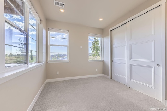 9436 E 57h Ave, Denver, CO 80238 - unfurnished bedroom featuring light carpet, recessed lighting, and a closet