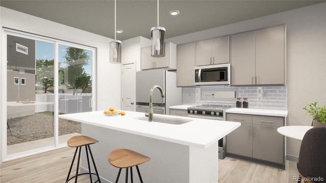 46545 Sunflower Ln, Bennett, CO 80102 - kitchen featuring pendant lighting, appliances with stainless steel finishes, a breakfast bar area, and gray cabinetry