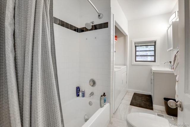 3000 S Sherman St, Englewood, CO 80113 - bathroom featuring independent washer and dryer, vanity, shower / tub combo with curtain, toilet, and baseboards