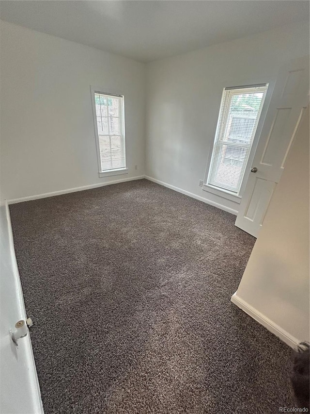 3000 S Sherman St, Englewood, CO 80113 - carpeted empty room featuring baseboards