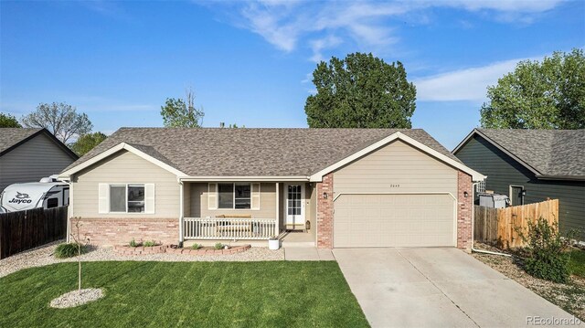 2045 Parkwood Dr, Johnstown, CO 80534 - ranch-style home featuring brick siding, covered porch, a garage, and driveway
