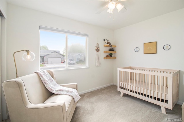 2045 Parkwood Dr, Johnstown, CO 80534 - carpeted bedroom with baseboards, a crib, and ceiling fan