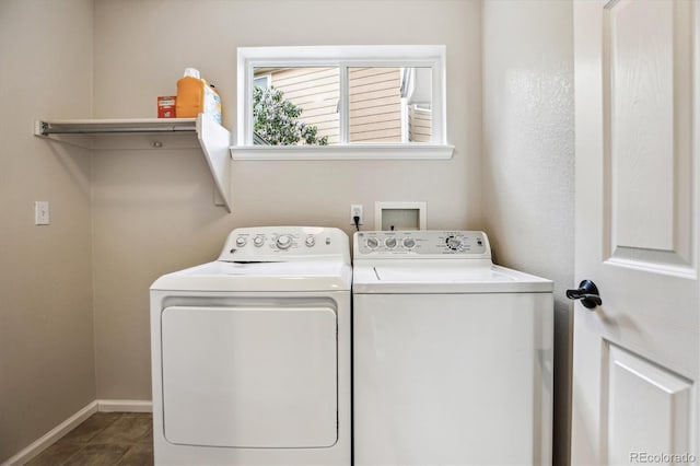 washroom with separate washer and dryer and baseboards