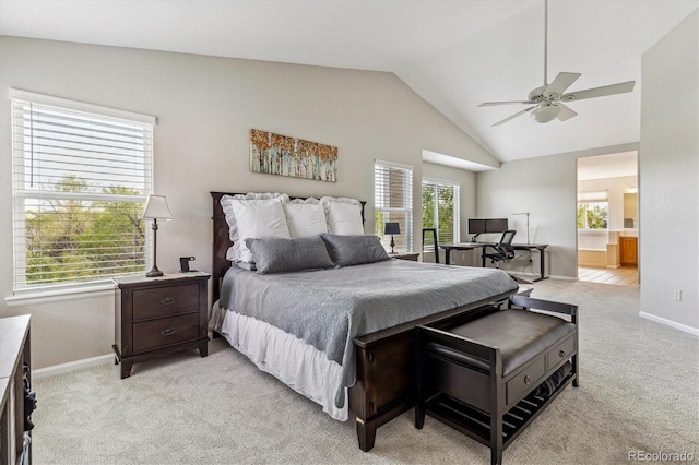 bedroom featuring light colored carpet, lofted ceiling, baseboards, connected bathroom, and ceiling fan