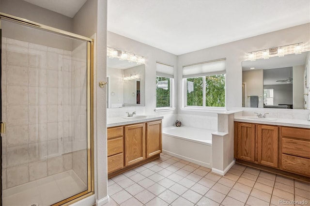 full bath with a shower stall, a garden tub, tile patterned flooring, and two vanities