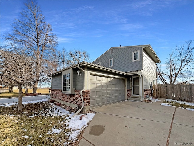 view of snow covered exterior with a garage