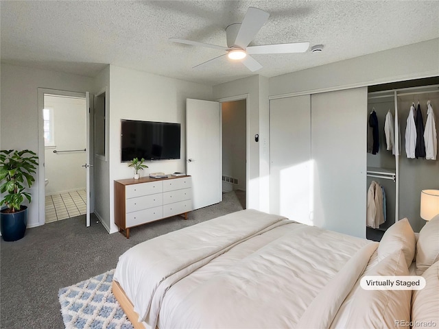 carpeted bedroom featuring connected bathroom, ceiling fan, a closet, and a textured ceiling