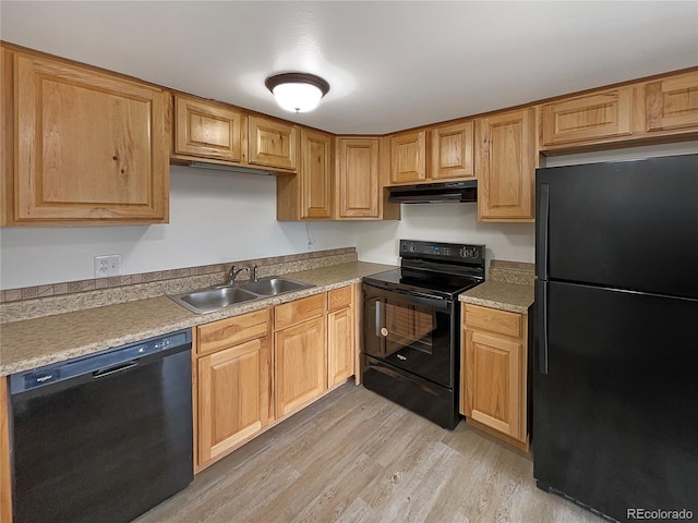 kitchen with light wood-type flooring, sink, and black appliances