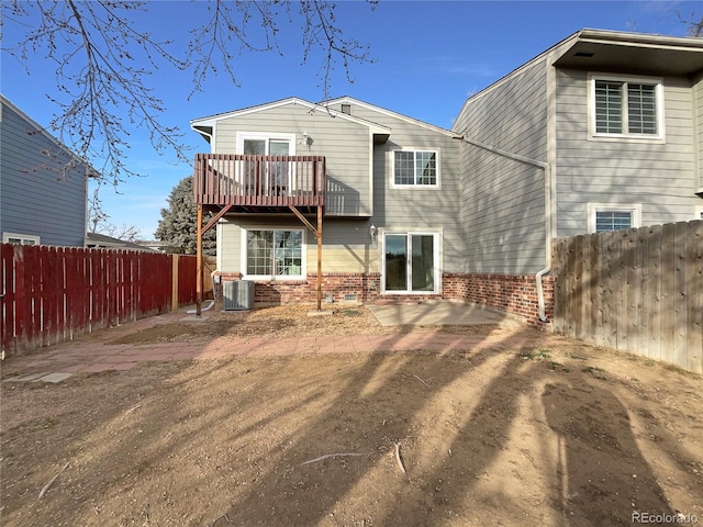 back of property with cooling unit and a patio area