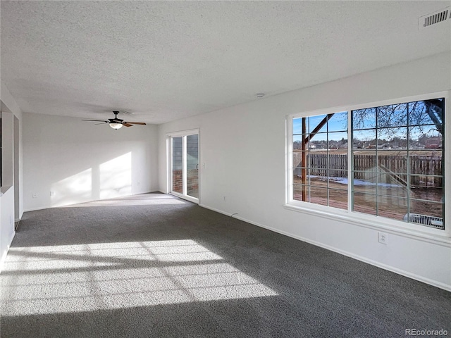 interior space featuring ceiling fan and a textured ceiling