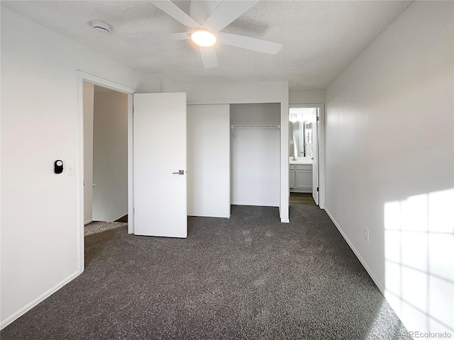 unfurnished bedroom with ceiling fan, a closet, a textured ceiling, and dark colored carpet