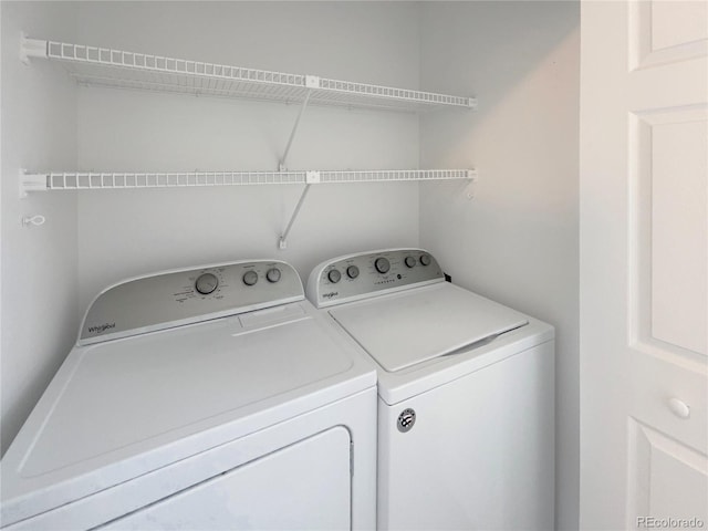 clothes washing area with washing machine and clothes dryer