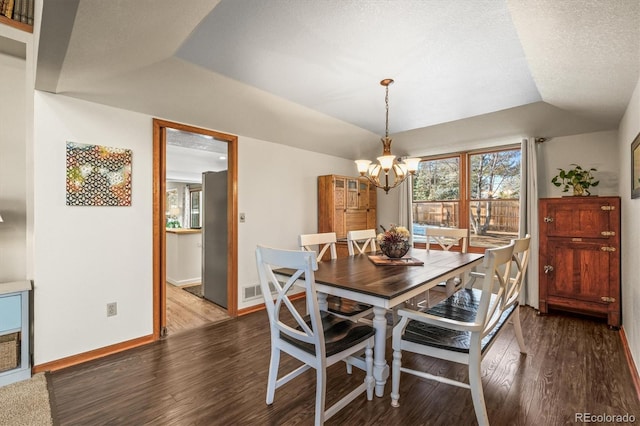 dining room with lofted ceiling, baseboards, an inviting chandelier, and wood finished floors