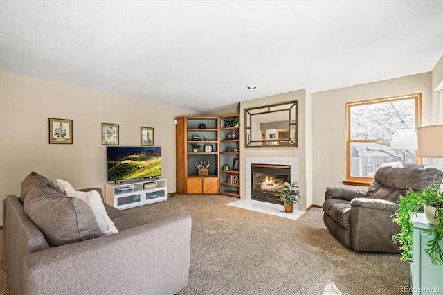 carpeted living room with a fireplace and baseboards