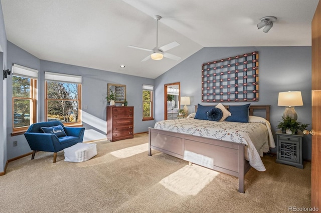 carpeted bedroom featuring baseboards, vaulted ceiling, and a ceiling fan