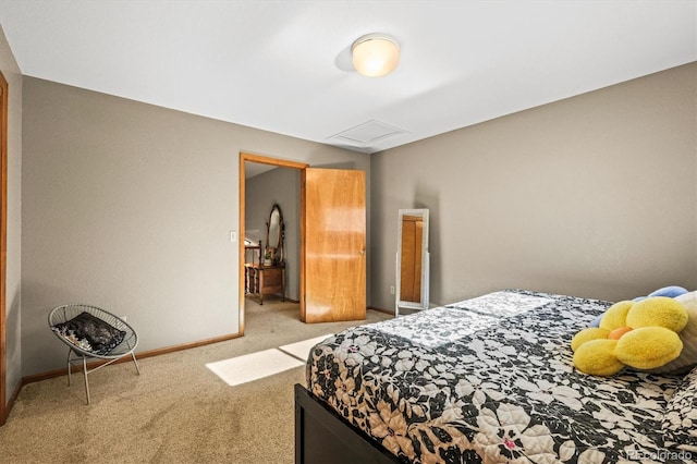 carpeted bedroom featuring attic access and baseboards