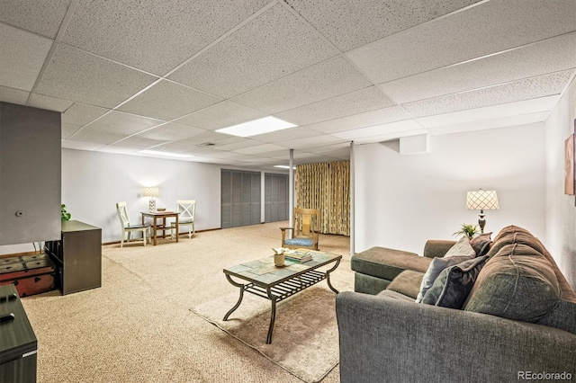 carpeted living room with a paneled ceiling