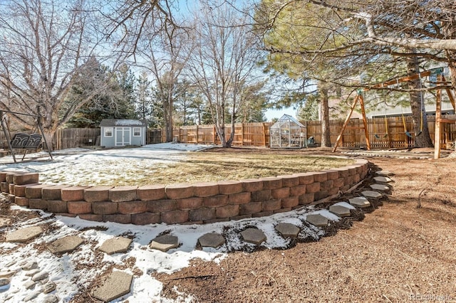 yard covered in snow with a storage unit