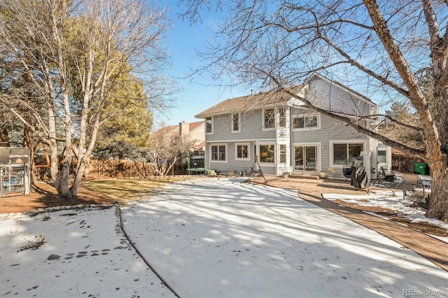 rear view of house with fence