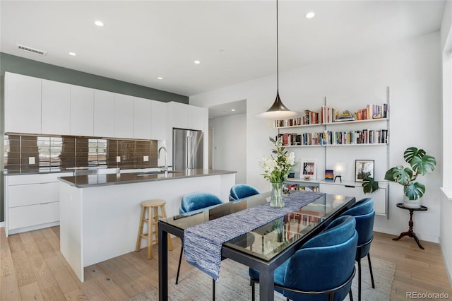 1300 N Ogden St Unit 304, Denver, CO 80218 - dining space featuring light wood finished floors and recessed lighting