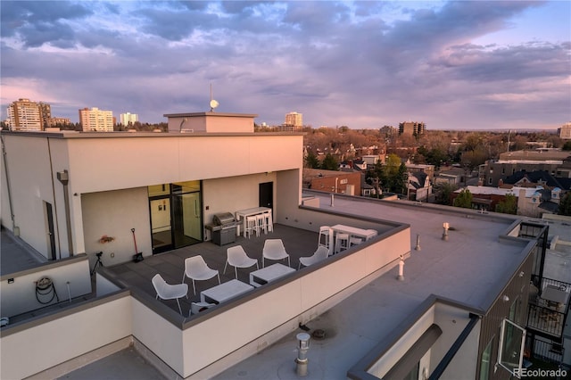 1300 N Ogden St Unit 304, Denver, CO 80218 - patio terrace at dusk with a balcony, grilling area, and a view of city