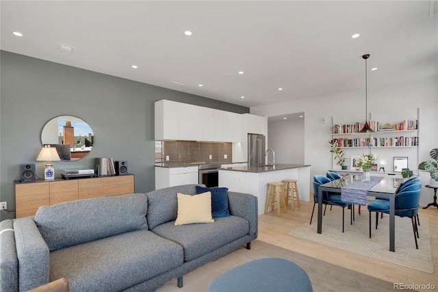 1300 N Ogden St Unit 304, Denver, CO 80218 - living room featuring light wood finished floors and recessed lighting